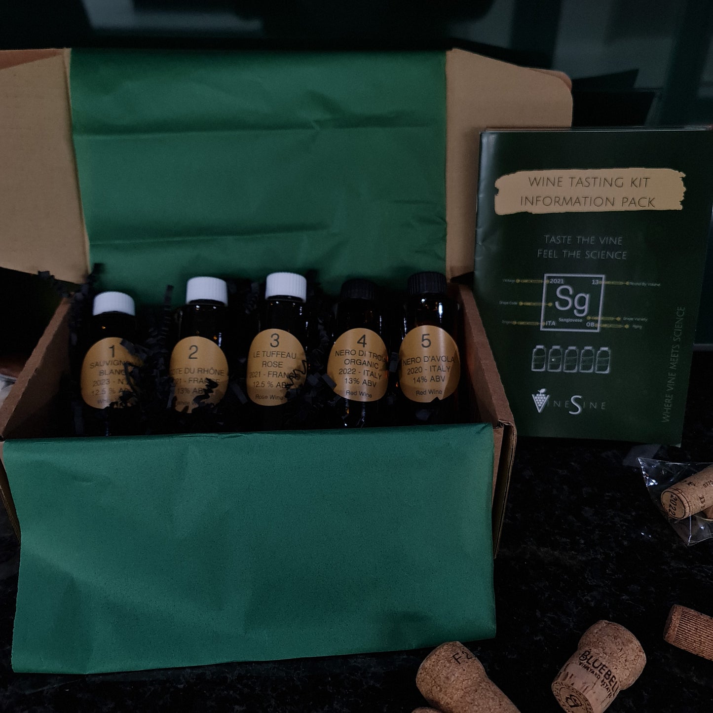 Vinesine At-home wine tasting kit in the classic brown box with 5 miniature bottles of wine, tasting information guide also know as tasting instruction
